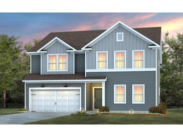 Charming two-story home with a two-car garage, landscaped yard, and welcoming entryway at 3231 Pelican Ln, Durham, NC 27703