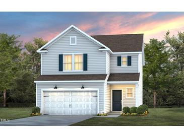 Charming two-story home featuring an attached two-car garage and manicured front lawn at 3233 Pelican Ln, Durham, NC 27703