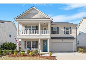 Charming two-story home with a welcoming front porch and well-maintained landscaping at 3422 Norway Spruce Rd, Raleigh, NC 27616