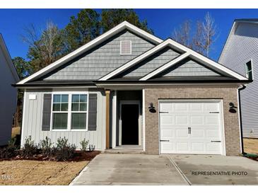 Charming single-story home with gray siding, brick accents, and an attached one-car garage at 41 Goldenrod Loop, Clayton, NC 27520