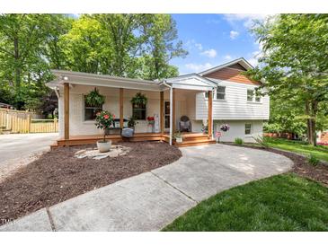 Charming home with a brick facade, covered porch, wooden posts and inviting curb appeal at 5505 Knollwood Rd, Raleigh, NC 27609