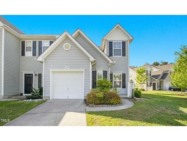 Charming townhouse featuring a one-car garage and well-maintained landscaping at 6539 Clarksdale Ln, Durham, NC 27713