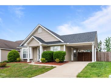 Charming home with covered parking, landscaped yard, and inviting facade at 7028 Pebble Brook Way, Rocky Mount, NC 27804