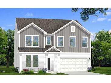 Charming two-story home featuring a modern design with a gray and white color scheme and a two-car garage at 788 Old Station Pointe, Angier, NC 27501
