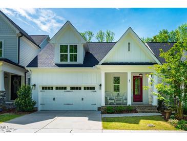 Charming two-story home with a red front door, attached garage, and well-maintained landscaping at 83 Vandalia Ave, Chapel Hill, NC 27516