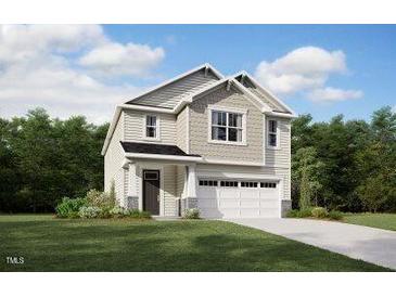 Charming two-story home with a manicured lawn, a two-car garage, and a welcoming front porch at 103 Vulcan St, Garner, NC 27529
