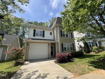 Charming two-story home with a garage, landscaped yard, and classic architectural details at 125 Occidental Dr, Holly Springs, NC 27540