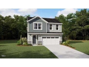 Charming two-story home featuring a gray exterior, complemented by a lush green lawn and a spacious two-car garage at 131 Vulcan St, Garner, NC 27529