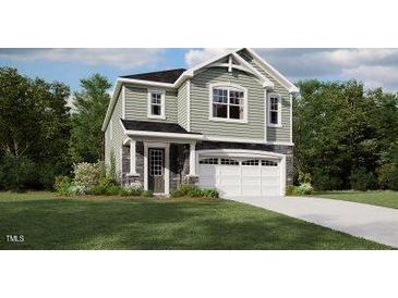Charming two-story home features a classic design, a two-car garage and manicured lawn at 135 Vulcan St, Garner, NC 27529