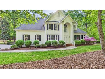 Charming white brick home featuring black shutters and lush landscaping, offering timeless curb appeal at 201 Johnstone Ct Ct, Durham, NC 27712