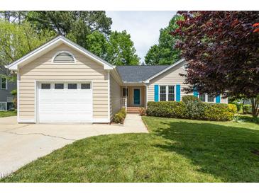 Charming single-story home featuring a one-car garage and vibrant blue shutters at 210 Needle Park Dr, Cary, NC 27513