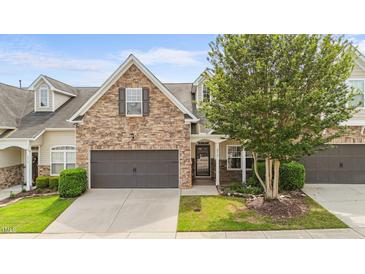 Charming two-story home featuring a stone facade, well-maintained landscaping, and a two-car garage at 3212 Imperial Oaks Dr, Raleigh, NC 27614