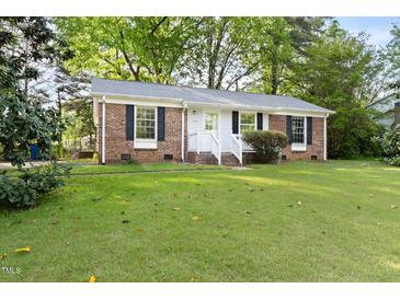 Charming single-story brick home with a well-maintained lawn and classic black shutters at 5802 Newhall Rd, Durham, NC 27713