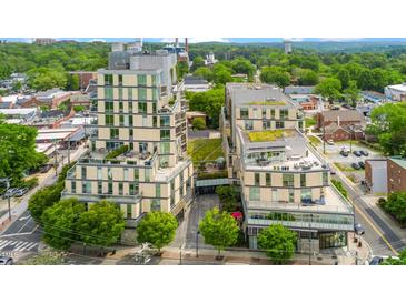 Stunning aerial view of a modern multi-story condominium complex with beautiful landscaping and rooftop terraces at 601 W Rosemary St # 905, Chapel Hill, NC 27516