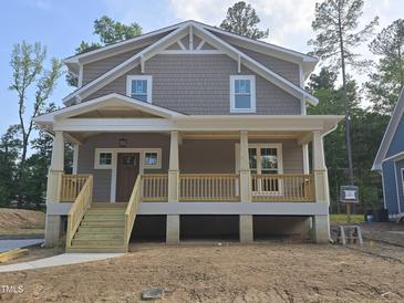 Charming two-story home with a covered front porch and wood railings at 1005 Forrestal Pl, Durham, NC 27707