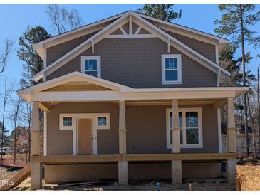 New construction craftsman-style home featuring a covered front porch with classic columns and a shingle facade at 1005 Forrestal Pl, Durham, NC 27707