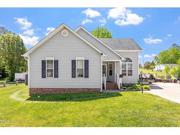 Charming single-story home with gray siding, black shutters, and a well-manicured lawn at 106 Northwinds Dr, Wendell, NC 27591