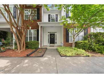 Charming townhome with brick accents, manicured landscaping, and a welcoming front entrance at 126 Star Thistle Ln, Cary, NC 27513