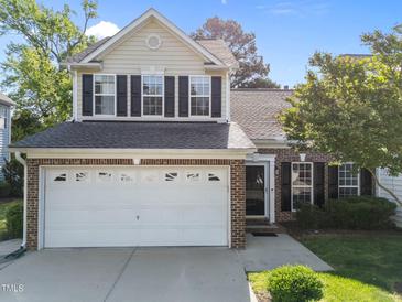 Charming two-story home featuring a two-car garage, brick accents, and well-maintained landscaping at 141 Hilda Grace Ln, Cary, NC 27519