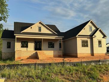 Charming home showcasing a brick foundation, covered porch, and classic architecture, perfect for modern living at 27 Batten Hill Ln, Selma, NC 27576