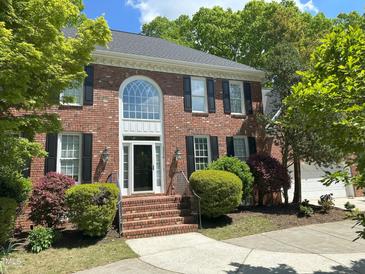 Charming two-story brick home with black shutters and a well-manicured lawn at 3316 Belspring Ln, Raleigh, NC 27612