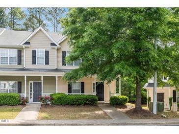 Charming townhome featuring a covered porch and well-maintained landscaping at 4000 Volkswalk Pl, Raleigh, NC 27610