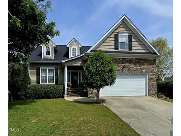 Charming two-story home featuring stone accents, a manicured lawn, and an attached two car garage at 503 Bellefont Ct, Knightdale, NC 27545