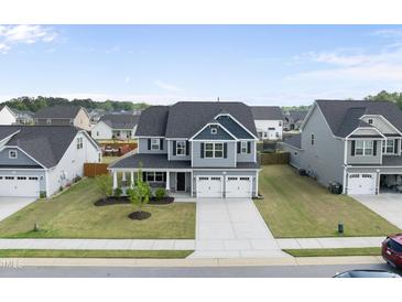Beautiful two-story home with a two-car garage and well-maintained lawn at 509 National Dr, Clayton, NC 27520