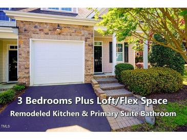 Charming townhome featuring a brick facade and a one-car garage at 5515 S Roxboro St # 23, Durham, NC 27713