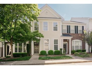 Charming two-story townhome with a well-maintained lawn and inviting front entrance at 5710 Corbon Crest Ln, Raleigh, NC 27612