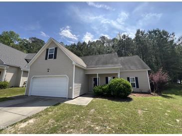 Charming home with a well-manicured lawn, attached garage, and traditional architectural details at 633 Prickly Pear Dr, Fuquay Varina, NC 27526