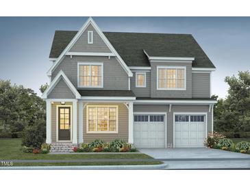 Charming two-story home with a classic design, well-manicured lawn, and an inviting front porch at 755 W Holly Springs Rd, Holly Springs, NC 27540