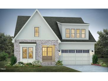 Charming two-story home with gray brick, white siding, an attached two-car garage, and manicured landscaping at 761 W Holly Springs Rd, Holly Springs, NC 27540