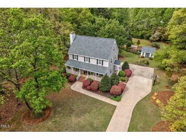 Charming two-story home featuring a welcoming front porch and lush landscaping at 817 S Creek Dr, Nashville, NC 27856