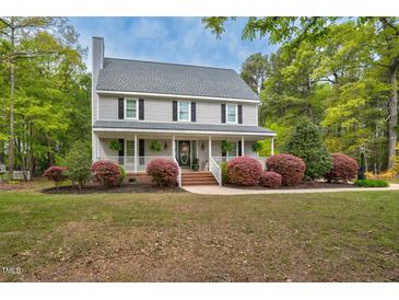 Charming two-story home featuring a lovely front porch, manicured landscaping, and welcoming curb appeal at 817 S Creek Dr, Nashville, NC 27856