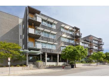 Modern condo building with balconies and lots of windows in an urban setting at 130 Hunt St # 107, Durham, NC 27701