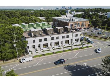 Modern townhomes featuring sleek designs, lush landscaping, and a prime location near the cityscape at 1302 Chamblee Hill Ct, Raleigh, NC 27608
