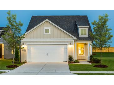 Charming single-Gathering home with a two-car garage, inviting curb appeal, and well-maintained landscaping at 1622 Garden Park Cir, Fuquay Varina, NC 27526