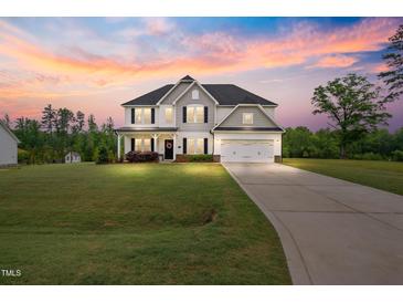 Beautiful two-story home featuring a manicured lawn and a two-car garage at 233 Berg St, Smithfield, NC 27577