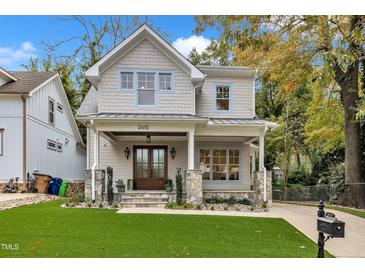 Charming two-story home featuring a welcoming front porch, manicured lawn, and beautiful stone accents at 2615 Bedford Ave, Raleigh, NC 27607