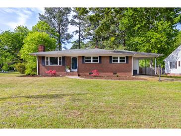 Charming single-story brick home featuring a well-maintained lawn and attached carport at 2702 Richwood Rd, Durham, NC 27705