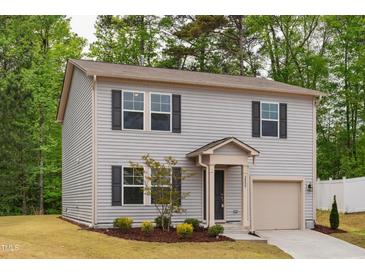 Charming two-story home with gray siding, black shutters, and a well-manicured lawn at 2800 Elsa Dr, Raleigh, NC 27610
