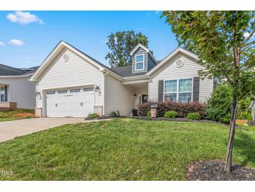 Charming single-Gathering home featuring a two-car garage, manicured lawn, and welcoming curb appeal at 3248 Castlerock Dr, Burlington, NC 27215