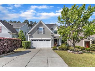 Charming two-story home featuring a two-car garage, manicured lawn, and mature landscaping at 4727 Smarty Jones Dr, Knightdale, NC 27545