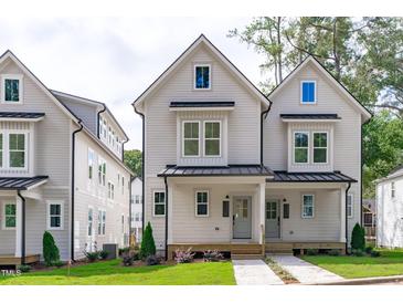Charming two-story home with a welcoming front porch and manicured lawn at 5049 Lundy Dr # 102, Raleigh, NC 27606