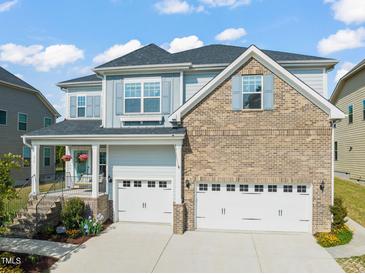 Charming two-story home with a brick and siding exterior and a two-car garage at 636 Copper Beech Ln, Wake Forest, NC 27587