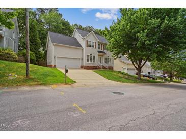 Charming two-story home with a two-car garage, landscaped lawn, and a traditional design at 7019 Bellard Ct, Raleigh, NC 27617