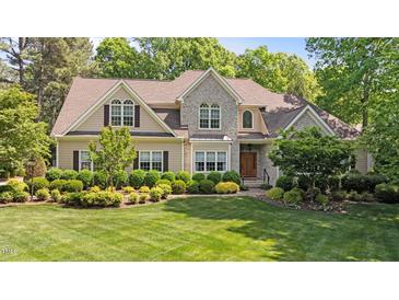 Charming two-story home with landscaped front yard and a combination of stone and siding exterior at 7212 Donneeford Rd, Wake Forest, NC 27587