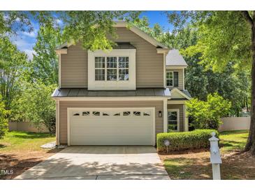 Charming two-story home with a two-car garage and neatly landscaped front yard at 8200 Shadow Stone Ct, Raleigh, NC 27613