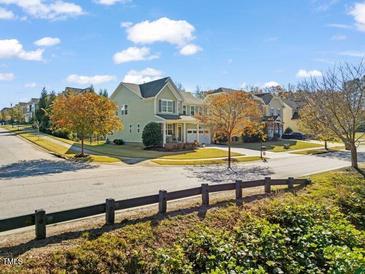 Charming two-story home with landscaped yard, covered porch, and a two-car garage on a sunny day at 901 Lemongrass Ln, Wake Forest, NC 27587